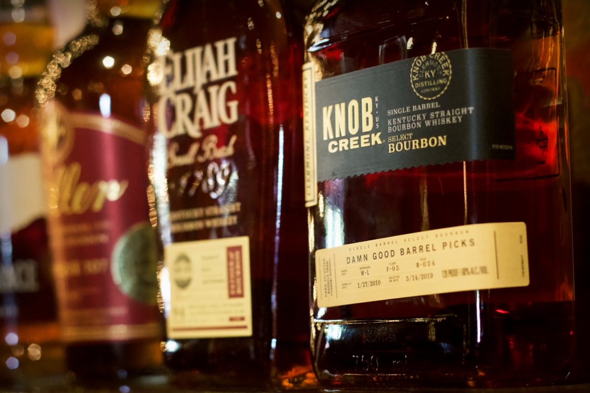 A close-up photo of a row of Damn Good Hospitality Barrel Pick Bourbons